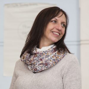 Female wearing a scarf smiling 