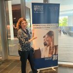 Female standing infront of a pull up banner