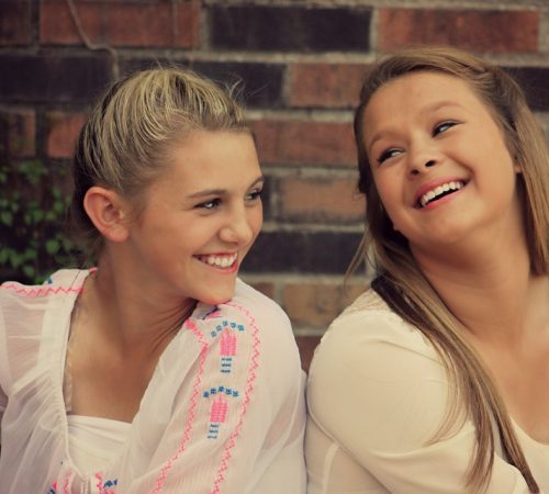 2 female teenagers laughing